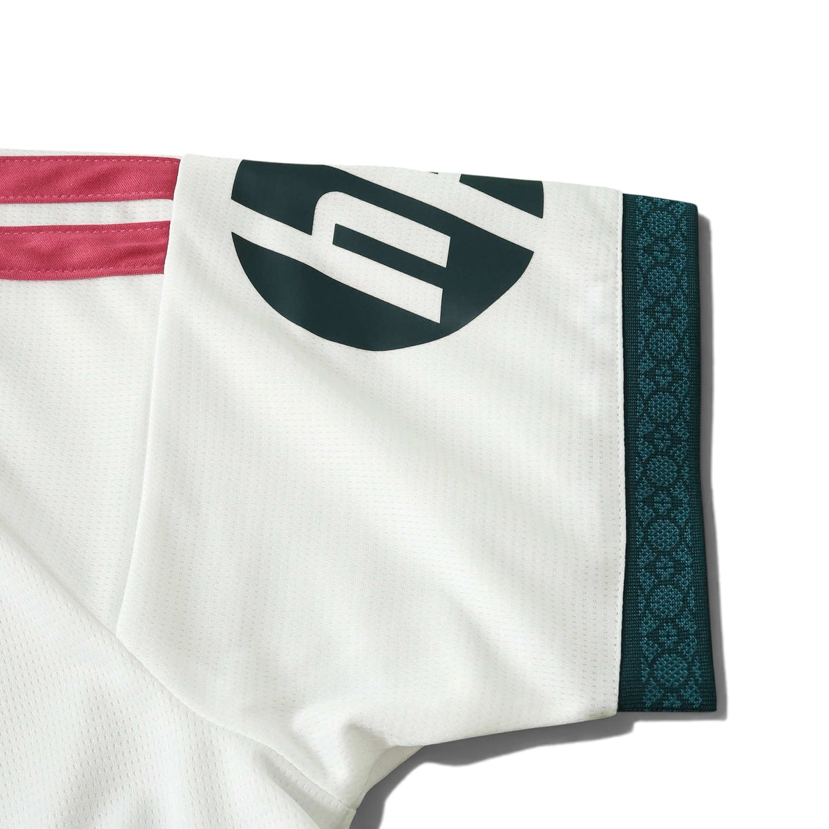 Europe Kits Real Madrid home jersey sleeve with pink stripes, dark green trim, and sponsor logo on white fabric